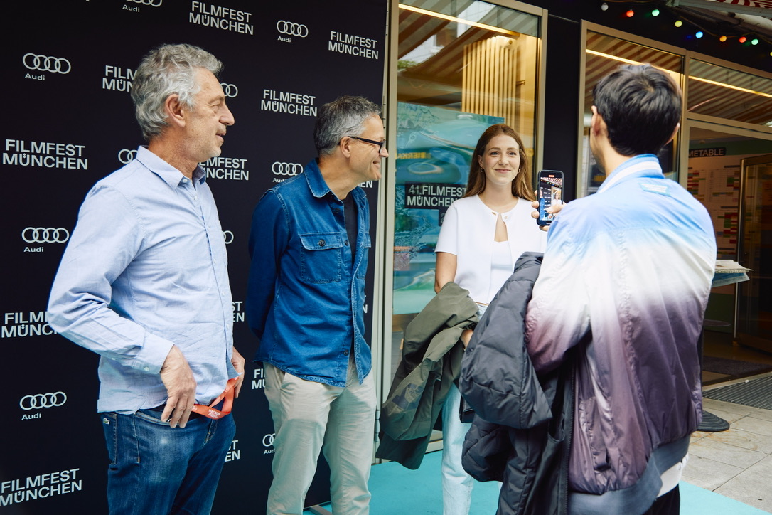 Celine Wempe and the La Práctica team arriving at the Munich Film Festival 2023, walking the red carpet, dressed elegantly and interacting with fans and the media.